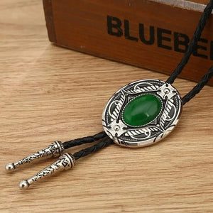 Bolo tie med oval sten och vågformad ram