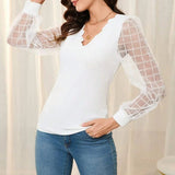 Blus med transparenta rutiga ärmar