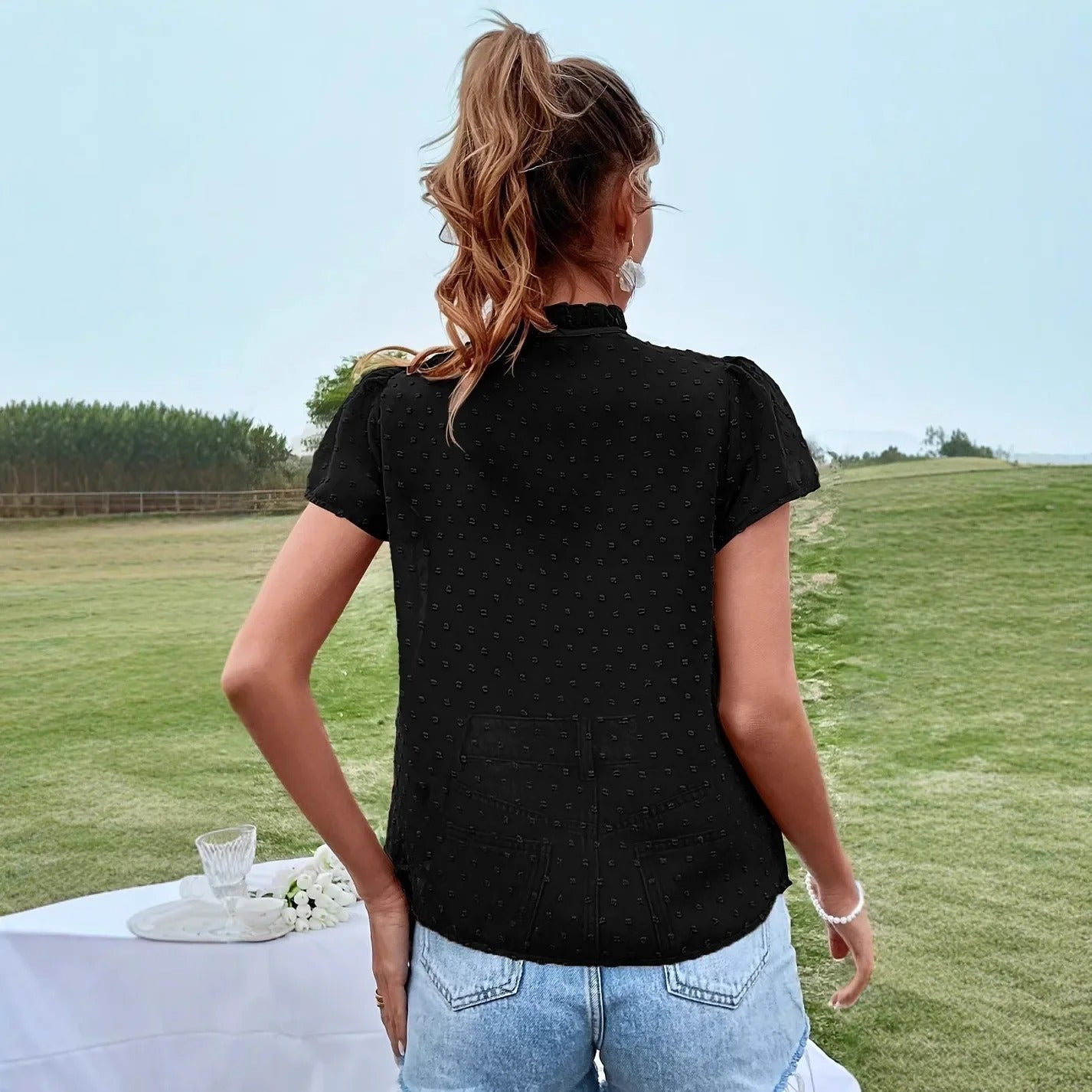 Svart blus med rosett